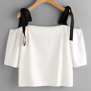 White off shoulder blouse with black bow ties